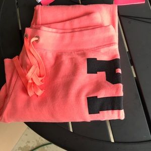 Salmon colored PINK brand sweatpants.